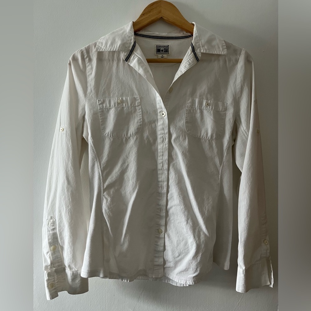 Converse woman’s blouse with roll tab button sleeves